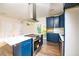 Modern kitchen with stainless steel appliances and blue cabinetry at 2407 Hart Street # B, Durham, NC 27703