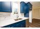 Modern kitchen with white countertops and blue cabinets at 2407 Hart Street # B, Durham, NC 27703