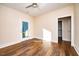Bright bedroom featuring wood-look floors and a private balcony at 2407 Hart Street # B, Durham, NC 27703
