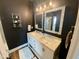 Modern bathroom with double vanity, large mirrors, and a walk-in shower at 26 Wildberry Ct, Rocky Mount, NC 27804