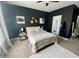 Cozy bedroom with dark walls, queen bed, and large window at 26 Wildberry Ct, Rocky Mount, NC 27804