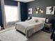 Bright bedroom with queen bed and large window, dark walls at 26 Wildberry Ct, Rocky Mount, NC 27804