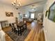 Open dining room with chandelier and view into living room at 26 Wildberry Ct, Rocky Mount, NC 27804