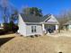 One-story house with gray siding, brick base, and a covered porch at 26 Wildberry Ct, Rocky Mount, NC 27804