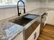 Modern farmhouse kitchen with stainless steel sink and granite countertops at 26 Wildberry Ct, Rocky Mount, NC 27804
