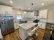 Modern kitchen with white cabinets, granite island, and stainless steel appliances at 26 Wildberry Ct, Rocky Mount, NC 27804