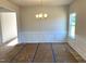 Bright dining room features modern lighting, wainscoting and hardwood flooring ready to be uncovered at 260 Olivia Crossing Ct # 9, Four Oaks, NC 27524