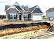 New single-Gathering home showcasing a modern design with two-car garage and professional landscaping at 260 Olivia Crossing Ct # 9, Four Oaks, NC 27524