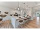 Modern kitchen featuring white cabinets, an island with bar seating, and pendant lighting at 260 Olivia Crossing Ct # 9, Four Oaks, NC 27524