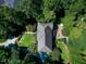 House with backyard patio, pool, and lush trees at 310 Bordeaux Ln, Cary, NC 27511