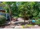 Brick patio with seating area, hot tub, and lush landscaping at 310 Bordeaux Ln, Cary, NC 27511