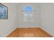 Bright bedroom with hardwood floors and an arched window at 312 Ashwick Dr, Efland, NC 27243