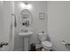 Clean and updated half bathroom with pedestal sink and toilet at 313 Page Square Dr, Cary, NC 27513