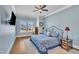 Spacious main bedroom with light blue walls, a king-size bed, and hardwood floors at 313 Warm Wind Dr, Clayton, NC 27527