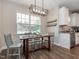 Dining area with farmhouse table and chandelier at 325 Quarryrock Rd, Holly Springs, NC 27540