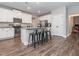 Modern kitchen with white cabinets, granite countertops, and stainless steel appliances at 325 Quarryrock Rd, Holly Springs, NC 27540