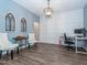 Home office with wood floors, white wainscoting, and a built-in desk at 325 Quarryrock Rd, Holly Springs, NC 27540