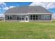 Home's back exterior showing the green yard, windows, and sliding door at 467 Ravensworth Dr, Garner, NC 27529