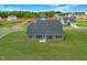 Aerial view of backyard showing green yard and the home's rear exterior at 467 Ravensworth Dr, Garner, NC 27529