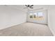 Spacious bedroom with a ceiling fan and a window view of trees and new construction at 467 Ravensworth Dr, Garner, NC 27529