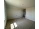 A bedroom with neutral walls, neutral carpet, and a small closet at 467 Ravensworth Dr, Garner, NC 27529