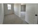 A bedroom with neutral walls, neutral carpet, and a window overlooking the yard at 467 Ravensworth Dr, Garner, NC 27529