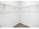 Empty walk-in closet with basic shelving, ready for customization and organization at 467 Ravensworth Dr, Garner, NC 27529
