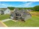 Aerial view showcasing the home's gray exterior, green yard, and landscaping at 467 Ravensworth Dr, Garner, NC 27529