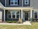 Inviting front entrance with stone accents, manicured landscaping, and craftsman-style door at 467 Ravensworth Dr, Garner, NC 27529