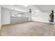 View of the empty garage showcasing the concrete flooring and garage door at 467 Ravensworth Dr, Garner, NC 27529