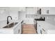 Modern kitchen with white cabinets, stainless steel appliances, and quartz countertops at 467 Ravensworth Dr, Garner, NC 27529