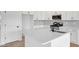 Bright kitchen with white cabinets, gray subway tile backsplash, and stainless steel appliances at 467 Ravensworth Dr, Garner, NC 27529