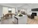 Open-concept kitchen featuring a large island, quartz countertops, and stainless steel appliances at 467 Ravensworth Dr, Garner, NC 27529