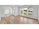 Spacious living room showcasing large windows for natural light and wood flooring at 467 Ravensworth Dr, Garner, NC 27529