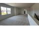A living room featuring neutral walls, neutral carpet, and a window overlooking the yard at 467 Ravensworth Dr, Garner, NC 27529