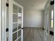 Home office with hardwood floors, natural light and glass panel french doors at 467 Ravensworth Dr, Garner, NC 27529