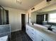 Modern bathroom featuring double sinks, black tile floor, and a walk-in shower at 505 Ravensworth Dr, Garner, NC 27529