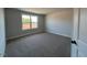 A light-filled bedroom features a large window and neutral carpeting at 505 Ravensworth Dr, Garner, NC 27529