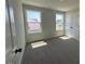 Bright bedroom features two windows, carpeted floor, and a closet with double doors at 505 Ravensworth Dr, Garner, NC 27529