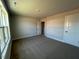 A carpeted bedroom offers natural light with large window and ample space at 505 Ravensworth Dr, Garner, NC 27529