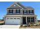 Charming two-story home featuring gray siding, black shutters and a two-car garage at 505 Ravensworth Dr, Garner, NC 27529