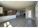 Open-concept living room showcasing modern flooring and access to kitchen and stairs at 505 Ravensworth Dr, Garner, NC 27529