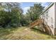 Backyard with wooden stairs leading to a back door at 520 Avon Ave, Burlington, NC 27215