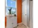 Bright bathroom featuring an orange accent wall, white vanity, and stylish floor tiles at 58 Northview Dr, Middlesex, NC 27557