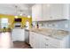 Bright kitchen features white cabinets, granite countertops, stainless steel appliances, and modern lighting at 58 Northview Dr, Middlesex, NC 27557