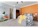 Spacious bedroom with a neutral and orange wall, dresser and king bed at 58 Northview Dr, Middlesex, NC 27557