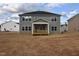 The backyard of the home, featuring a covered porch and a view of neighboring houses at 60 Accord Dr, Youngsville, NC 27596
