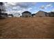 A spacious backyard with a view of the back of the house and neighboring homes at 60 Accord Dr, Youngsville, NC 27596