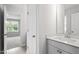Bathroom features a modern vanity with quartz countertop and a view into an adjacent room at 60 Accord Dr, Youngsville, NC 27596
