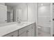 Bathroom view highlighting the vanity with quartz countertop and a glimpse into the shower/tub area at 60 Accord Dr, Youngsville, NC 27596